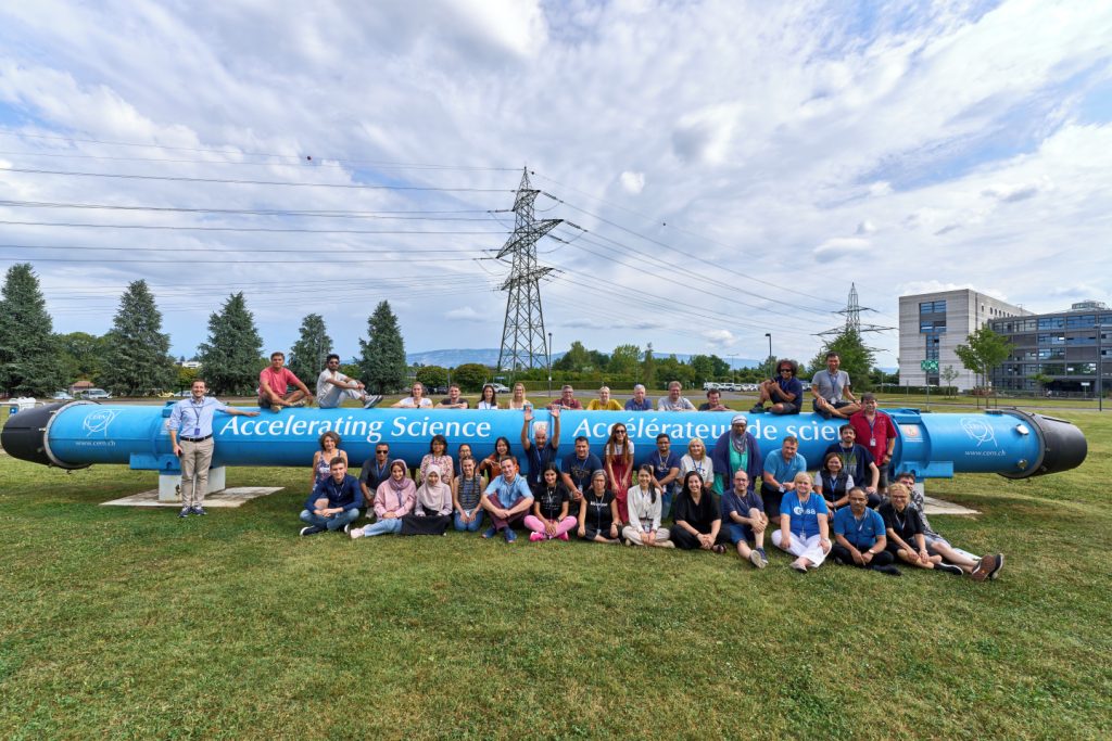 Group picture of teachers in front of blue tube
